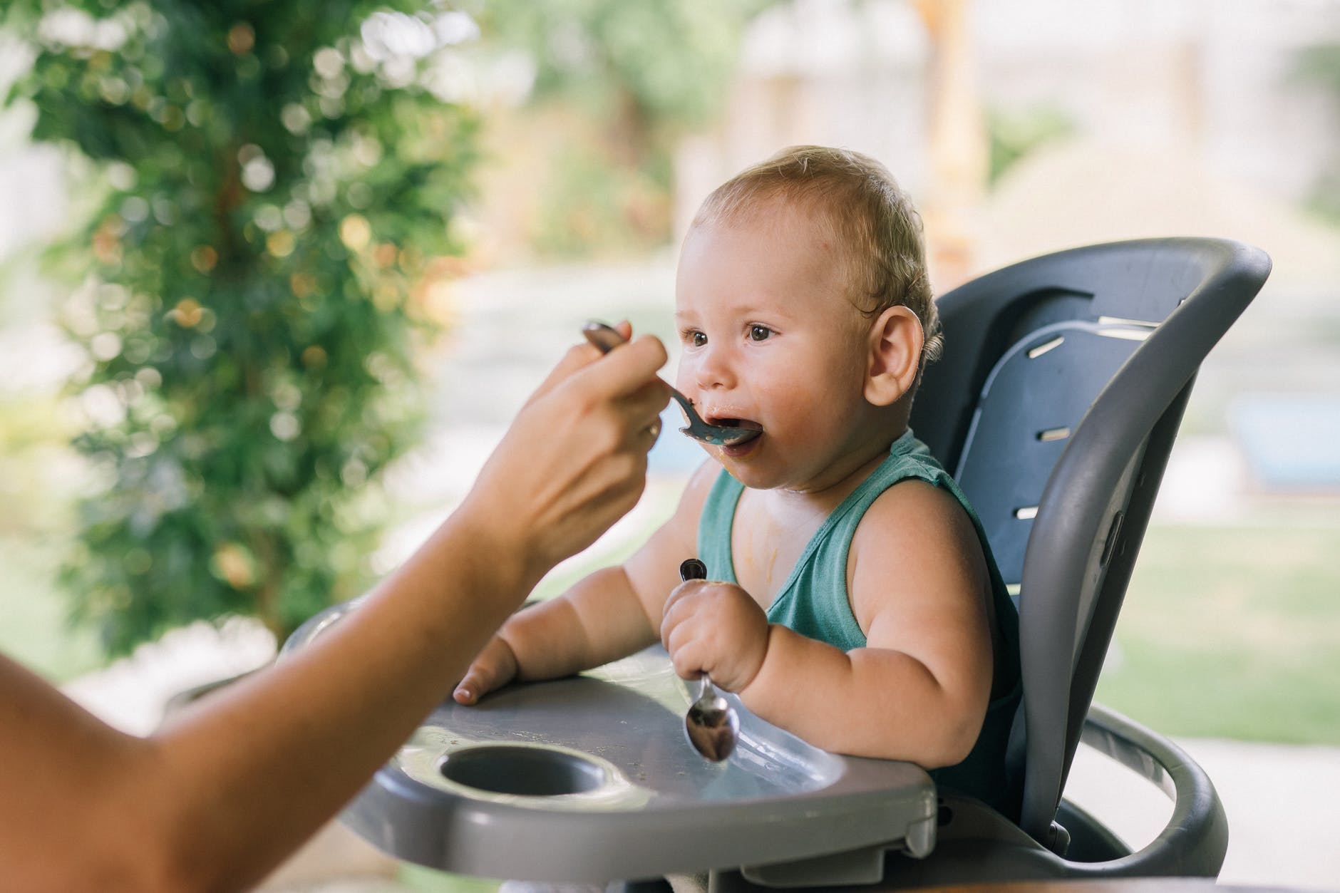 photo of baby eating on a chair